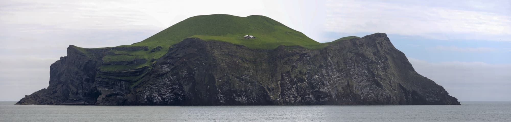 Island cliffs in the Westman Islands (Vestmannaeyjar), Iceland, from the sea.