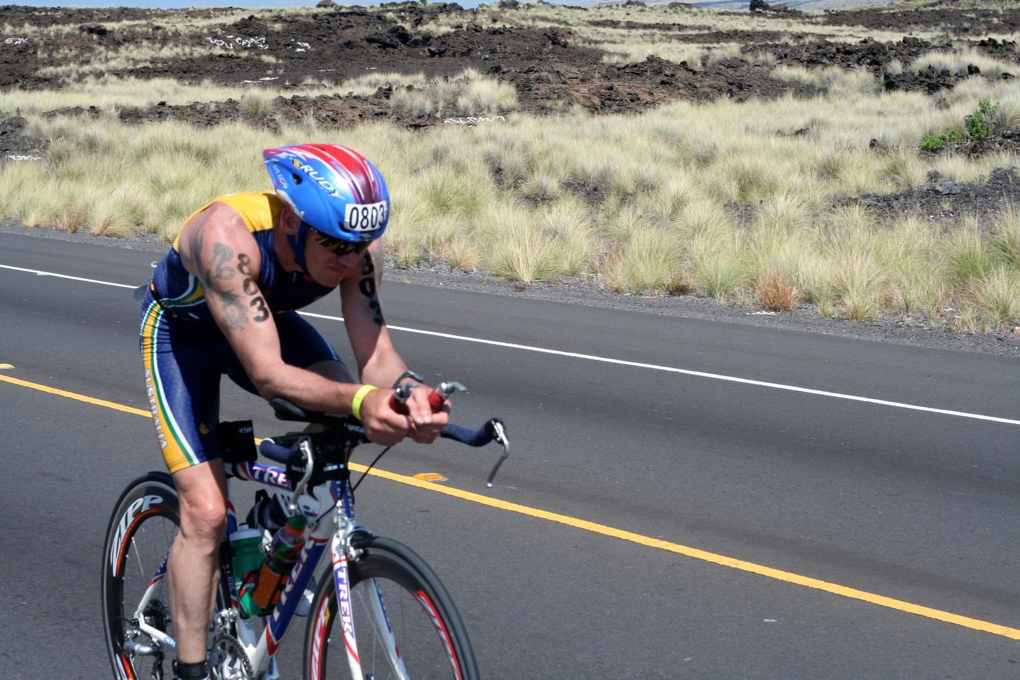 A cyclist on the 2007 Ironman World Championship bike course across the lava fields of Hawaii.