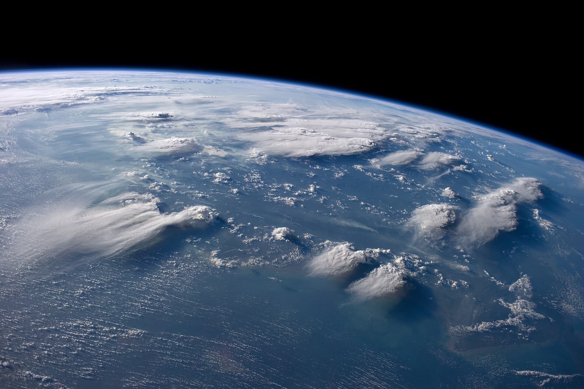 Thunderheads over Borneo seen from the International Space Station, the curve of the Earth behind.