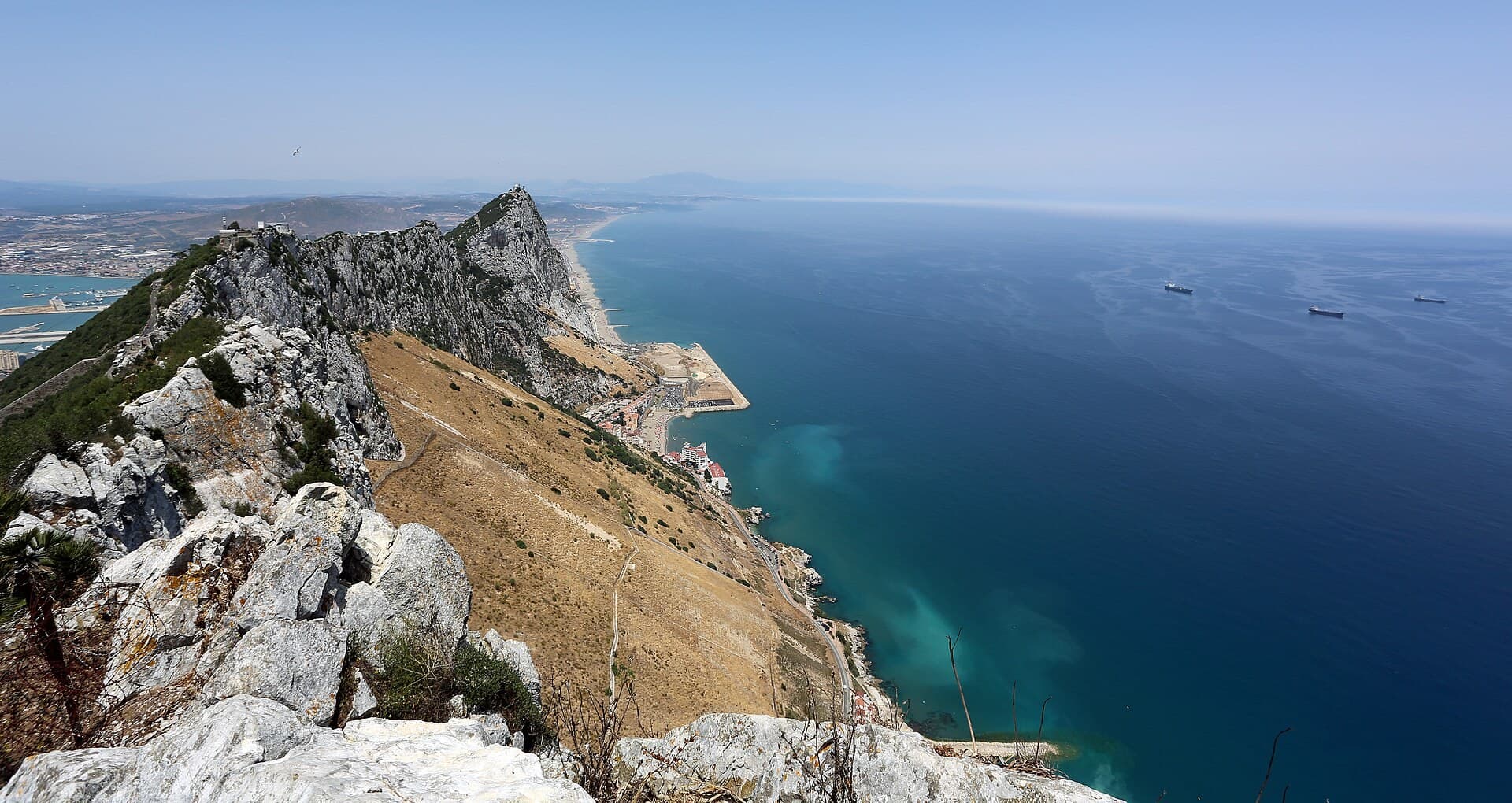 The ridge of the Rock of Gibraltar running down to the sea, Spain beyond.