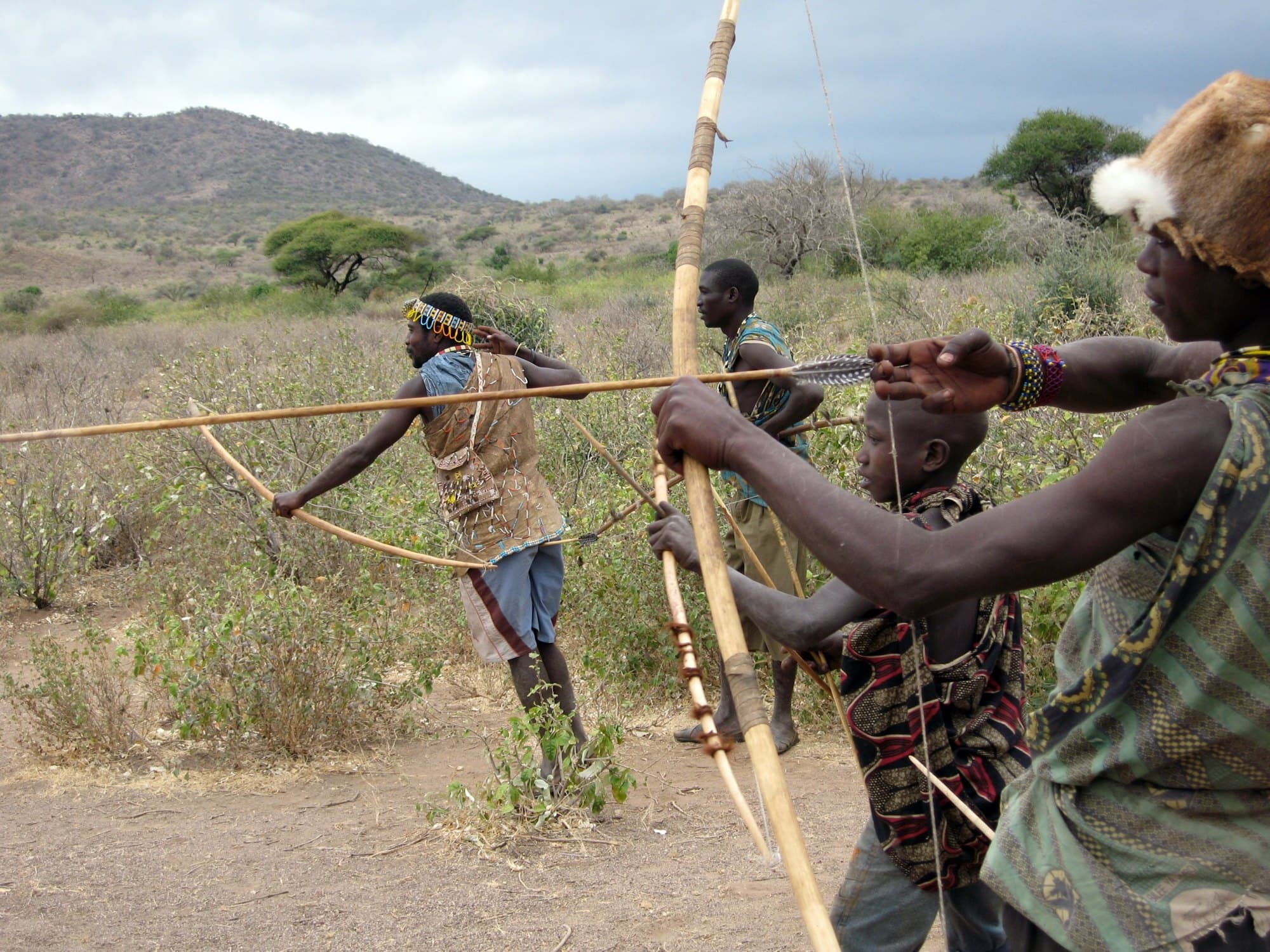 Hadza (Hadzabe) hunters with bows in the bush, Tanzania.
