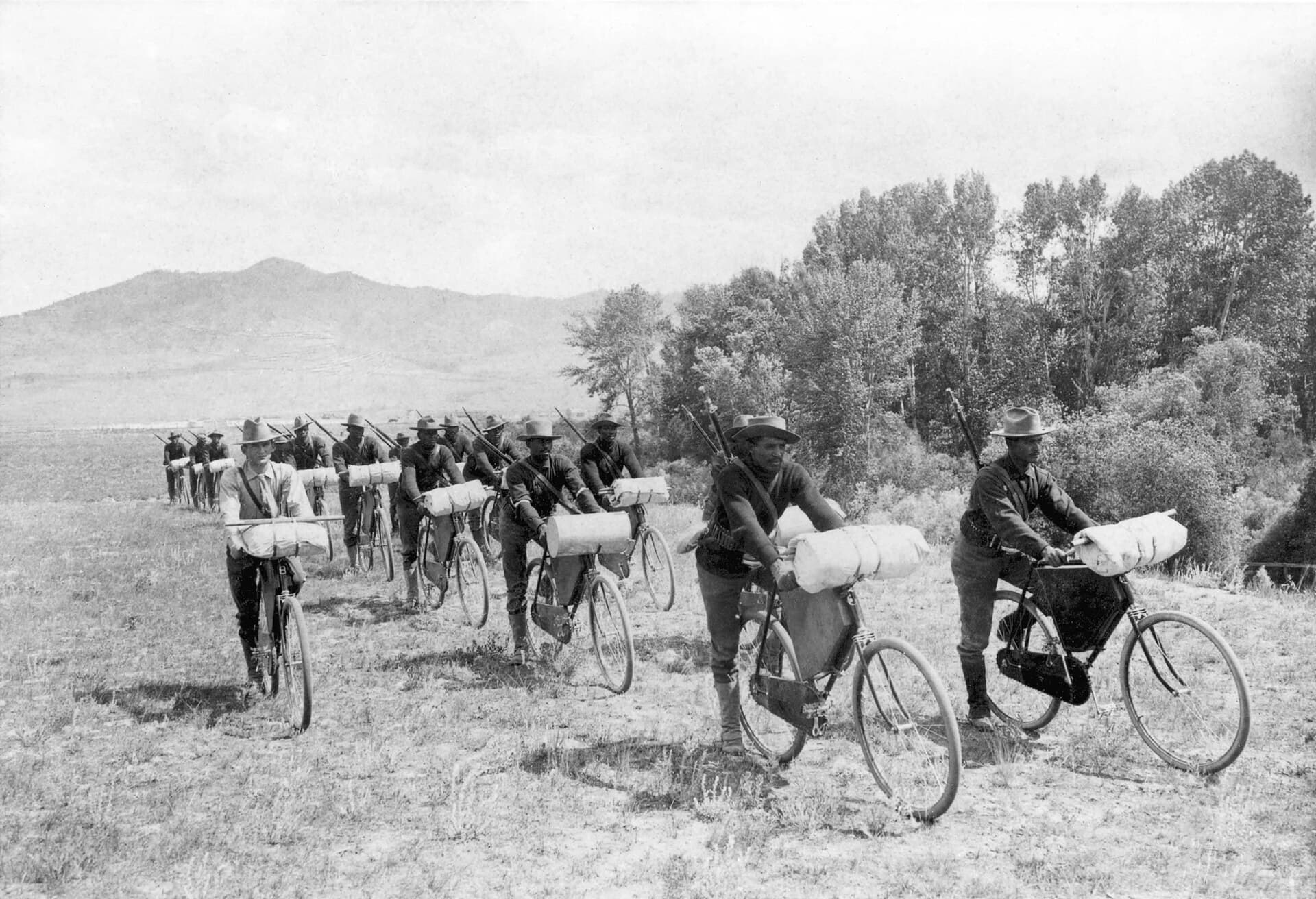 Soldiers of the 25th Infantry Bicycle Corps with loaded bicycles in open country, Montana, 1897.