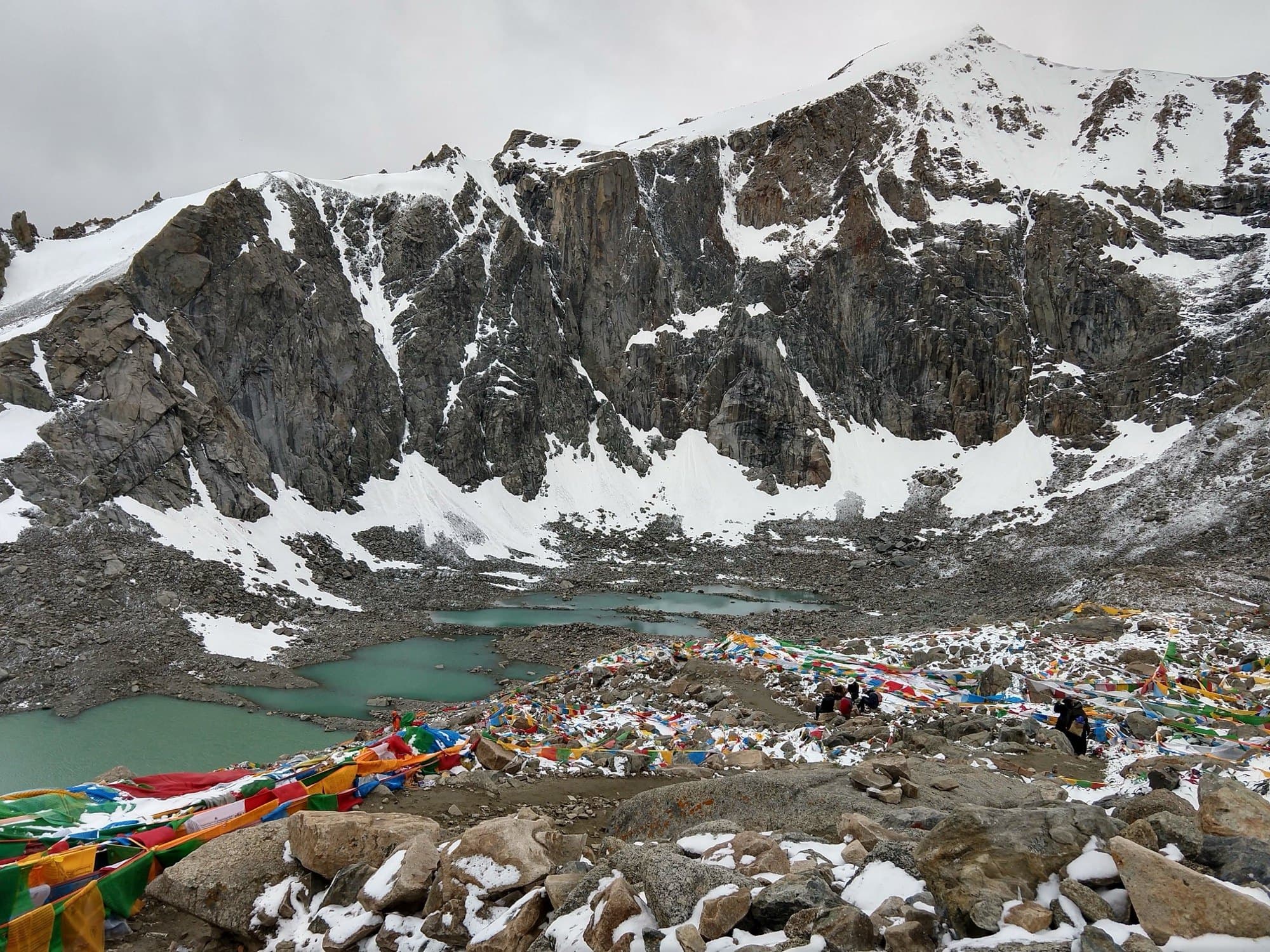 Gauri Kund lake and prayer flags below Drolma La on the Kailash kora.
