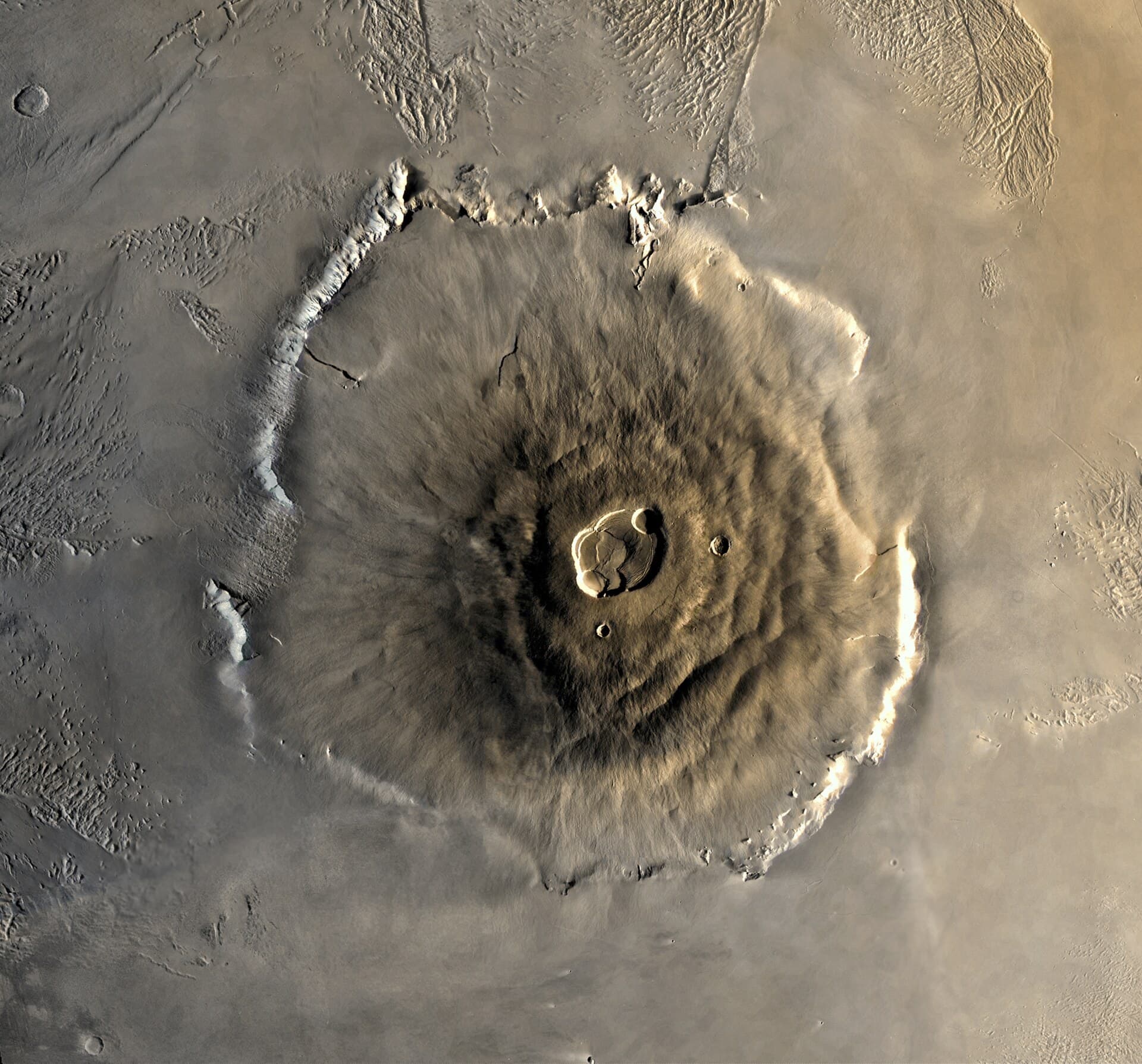 Olympus Mons on Mars seen from orbit, its caldera and cliff edge.