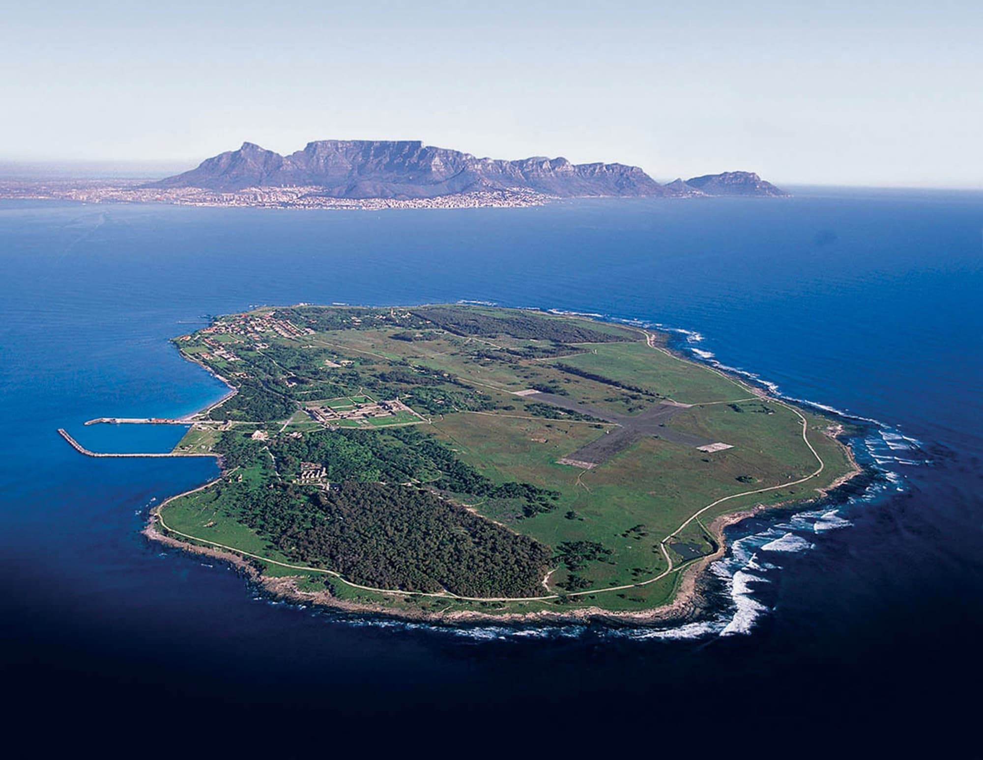 Aerial of Robben Island with Table Mountain and the Cape mainland across the water.